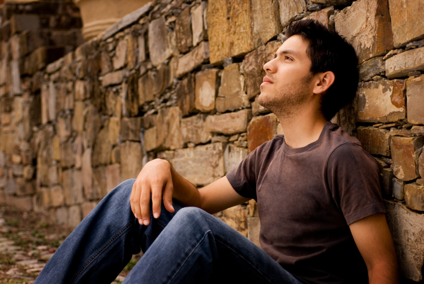 man leaning against wall